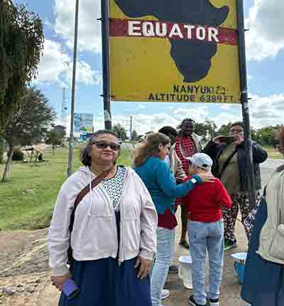 Family safari in Kenya with travelers visiting the Equator landmark in Nanyuki, enjoying a memorable sightseeing stop during their African family adventure